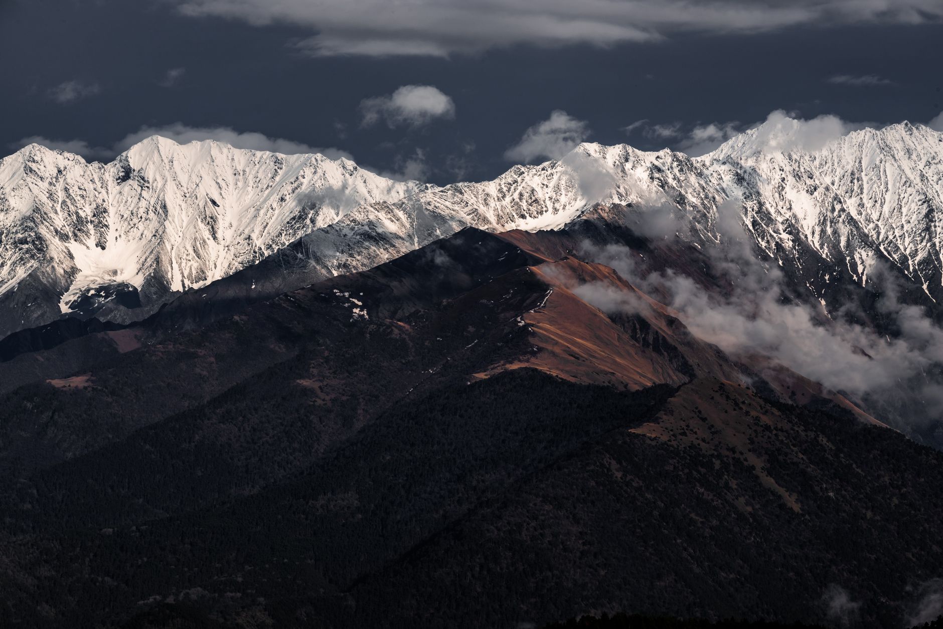 Dramatic mountain range under shifting light
